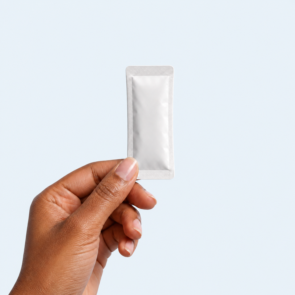 Hand holding one daily prebiotic packet